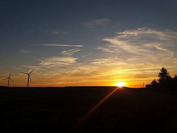 Větrné elektrárny při západu slunce.
